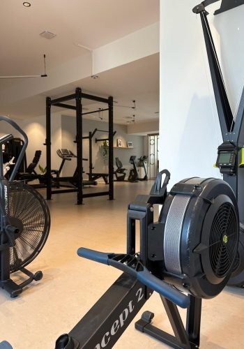 Gros plan sur un rameur et machines de fitness en fond